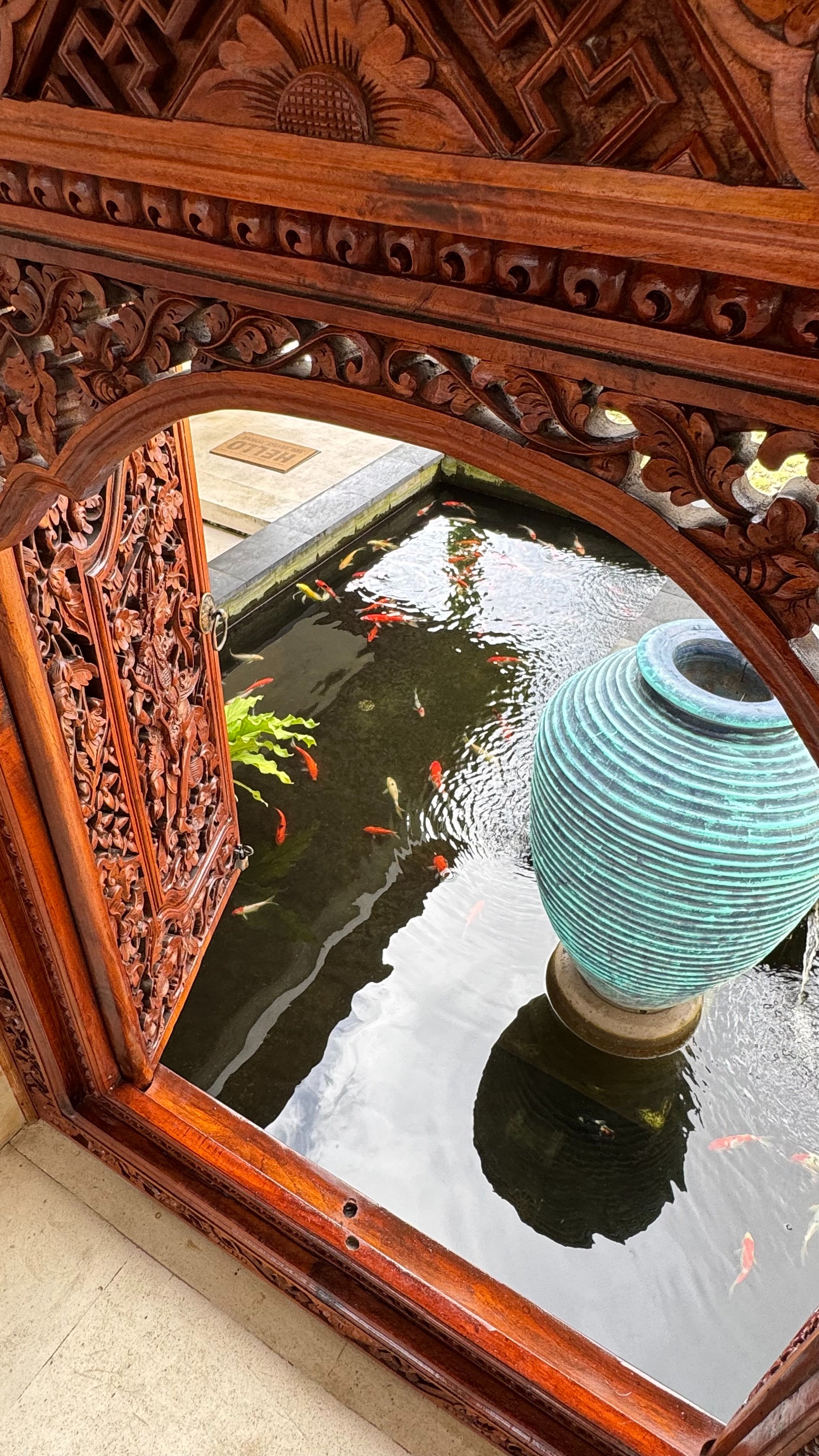 Koi pond through a carved archway